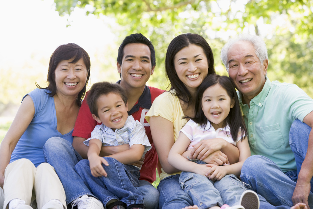 Extended Family Sitting Outdoors Smiling