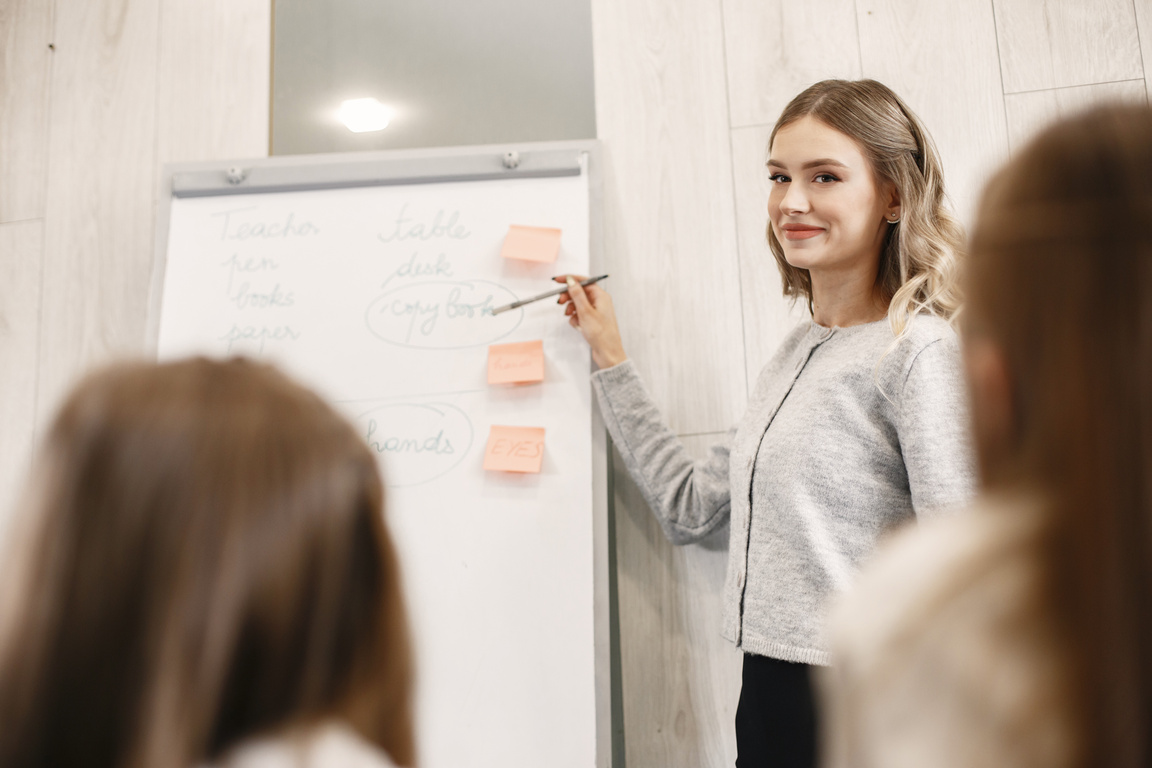 A Woman Discussing in Front of the Whiteboard