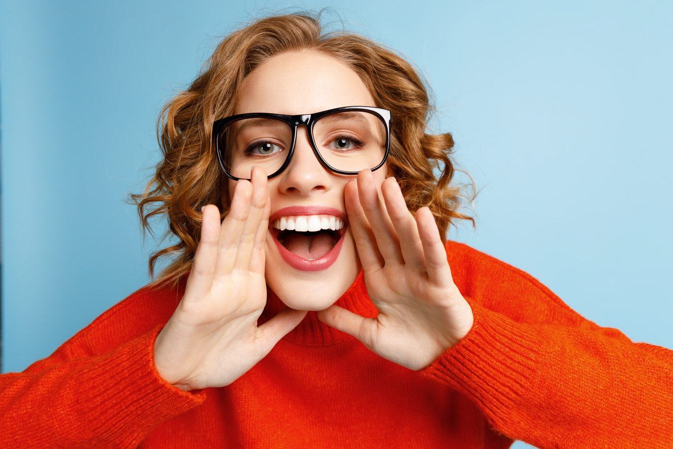 Excited young woman making announcement